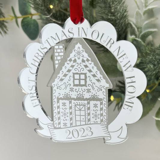 Silver mirrored engraved hanging tree Ornament, to celebrate Christmas in a new home. Featuring a pretty gingerbread house in the middle of a scalloped edge.