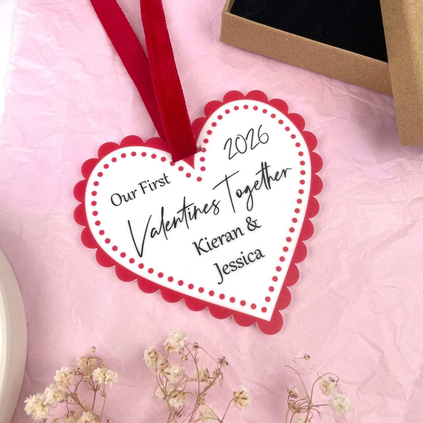 White and red acrylic printed valentines day heart customised with 'Our first valentines together 2026' 'Kieran & Jessica'. Made by The Bespoke Workshop.