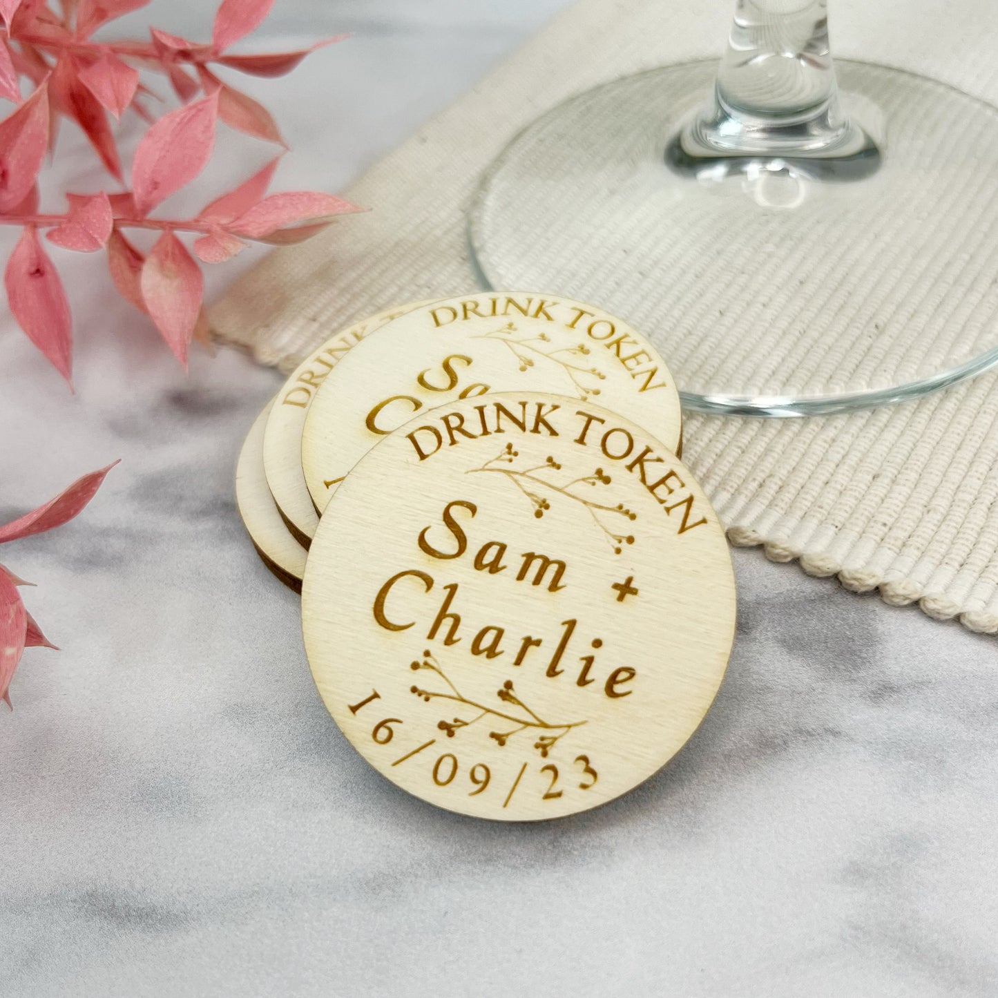 Rustic wooden drinks tokens designed for wedding parties. Personalised by laser engraving the couples names and dates made by The Bespoke Workshop