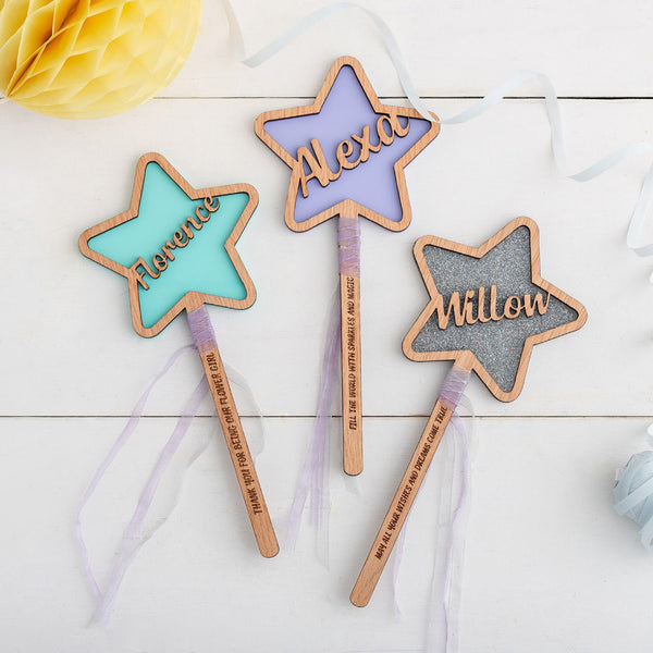 blue star shaped flower wands with sat on a white wooden background with some party decorations