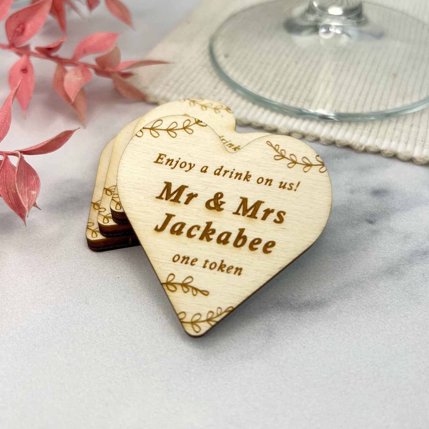 Heart shaped rustic wedding tokens can be personalised by engraving the couples names by The bespoke workshop