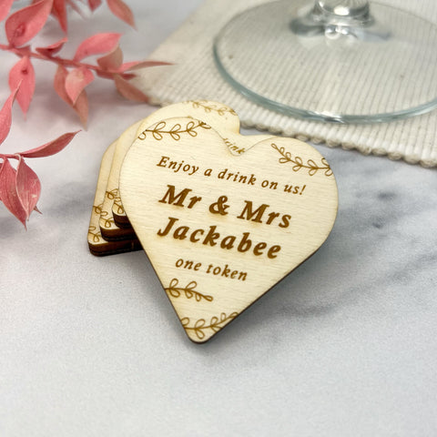 Heart shaped rustic wedding tokens can be personalised by engraving the couples names by The bespoke workshop