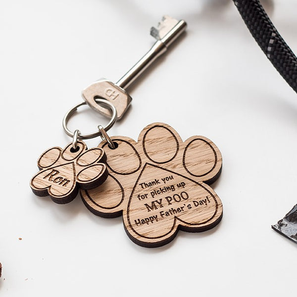 Paw print keyring engraved with 'Thank you for picking up my poo, Happy Father's Day!' Made by The Bespoke Workshop