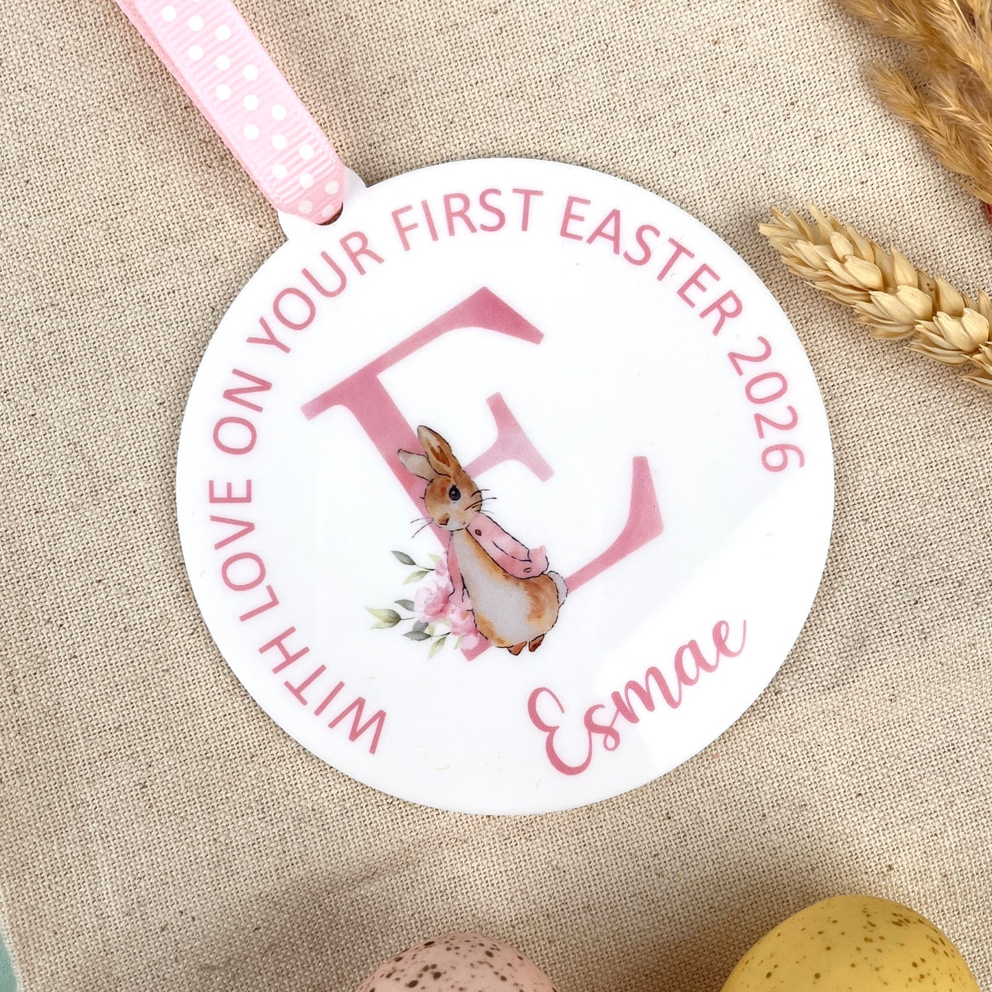 A round Baby's Easter Keepsake Decoration with Personalised name and wording, illustrated with a watercolour of Flopsy Bunny