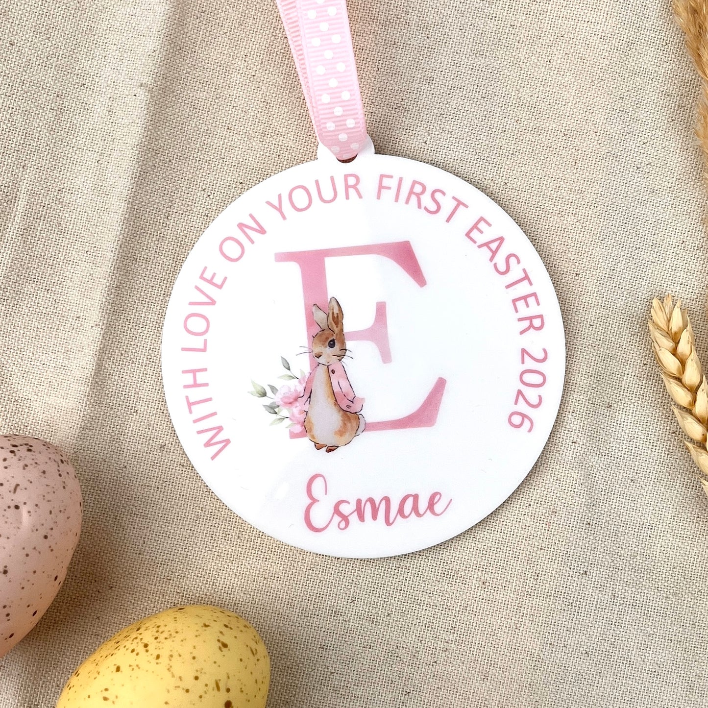 A round Baby's Easter Keepsake Decoration with Personalised name and wording, illustrated with a watercolour of Flopsy Bunny
