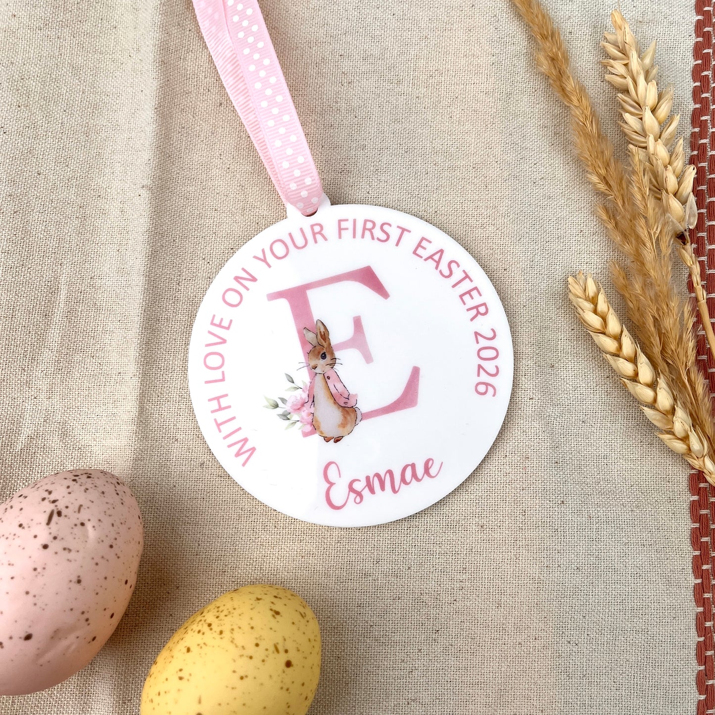 A round baby's Easter Keepsake Decoration with Personalised name and wording, illustrated with a watercolour of Flopsy Bunny