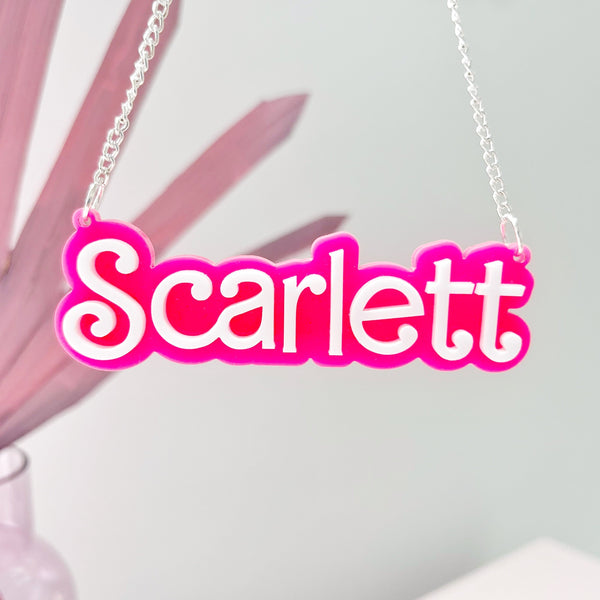 Laser cut custom acrylic name necklace in Barbie pink and white lettering. Made by The Bespoke Workshop
