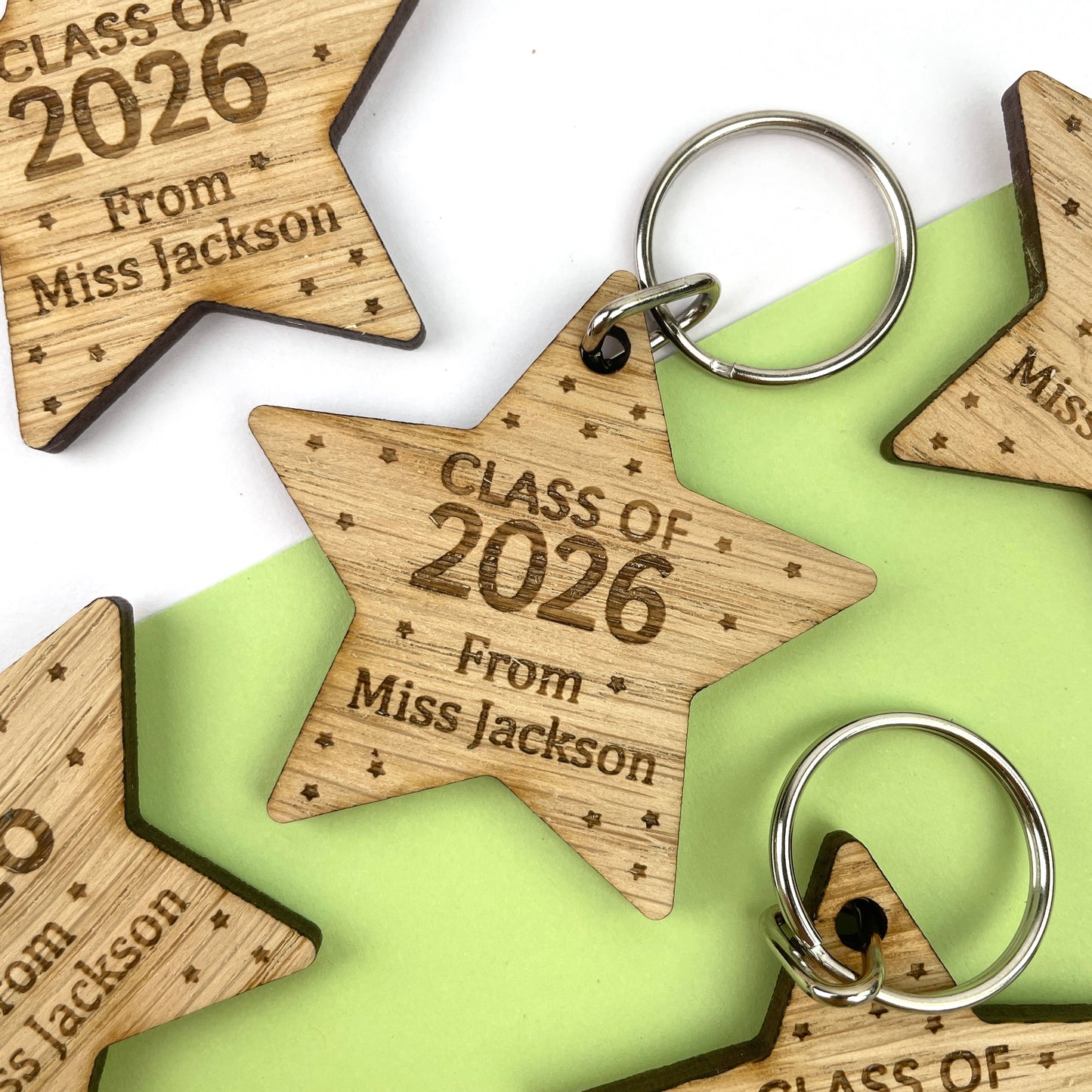 A wooden star-shaped keyring with engraved text celebrating 'Class of 2026', along with the name of the teacher.