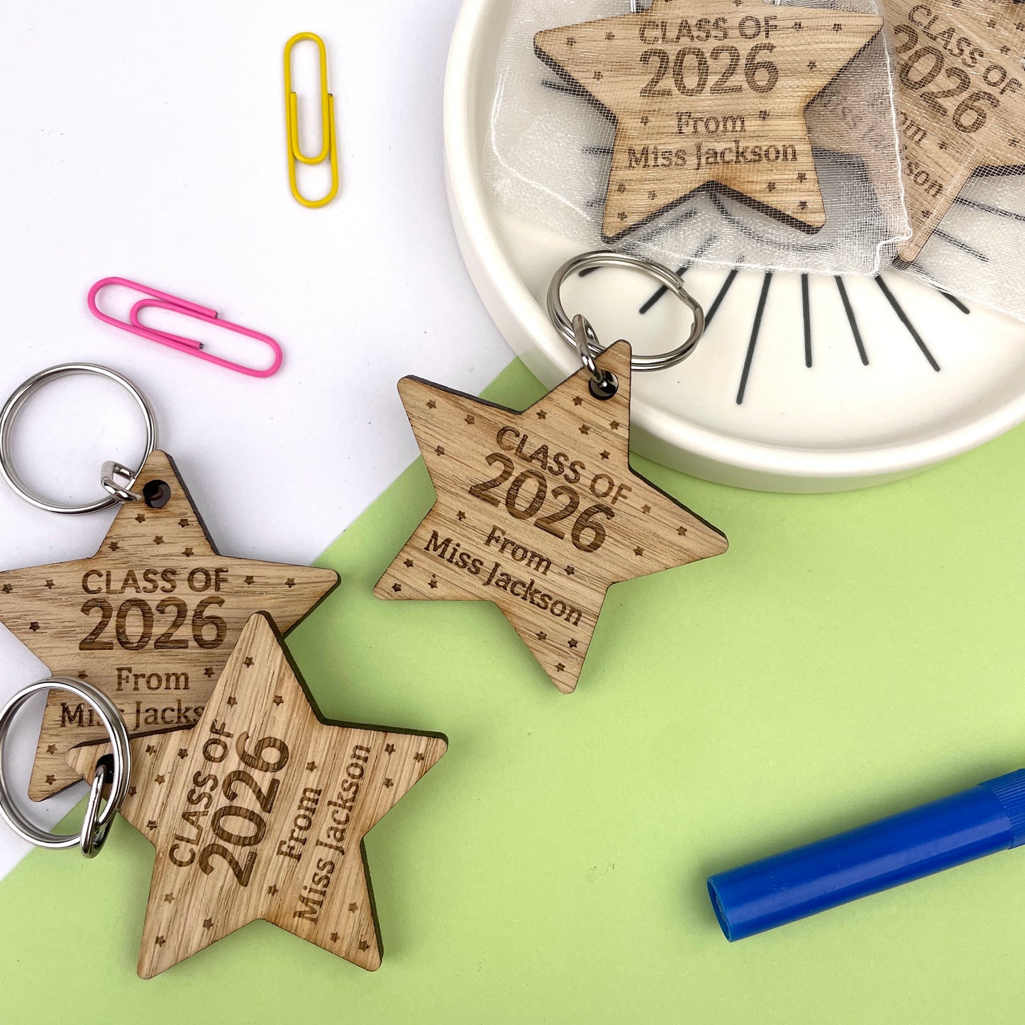 A wooden star-shaped keyring with engraved text celebrating 'Class of 2026', along with the name of the teacher.