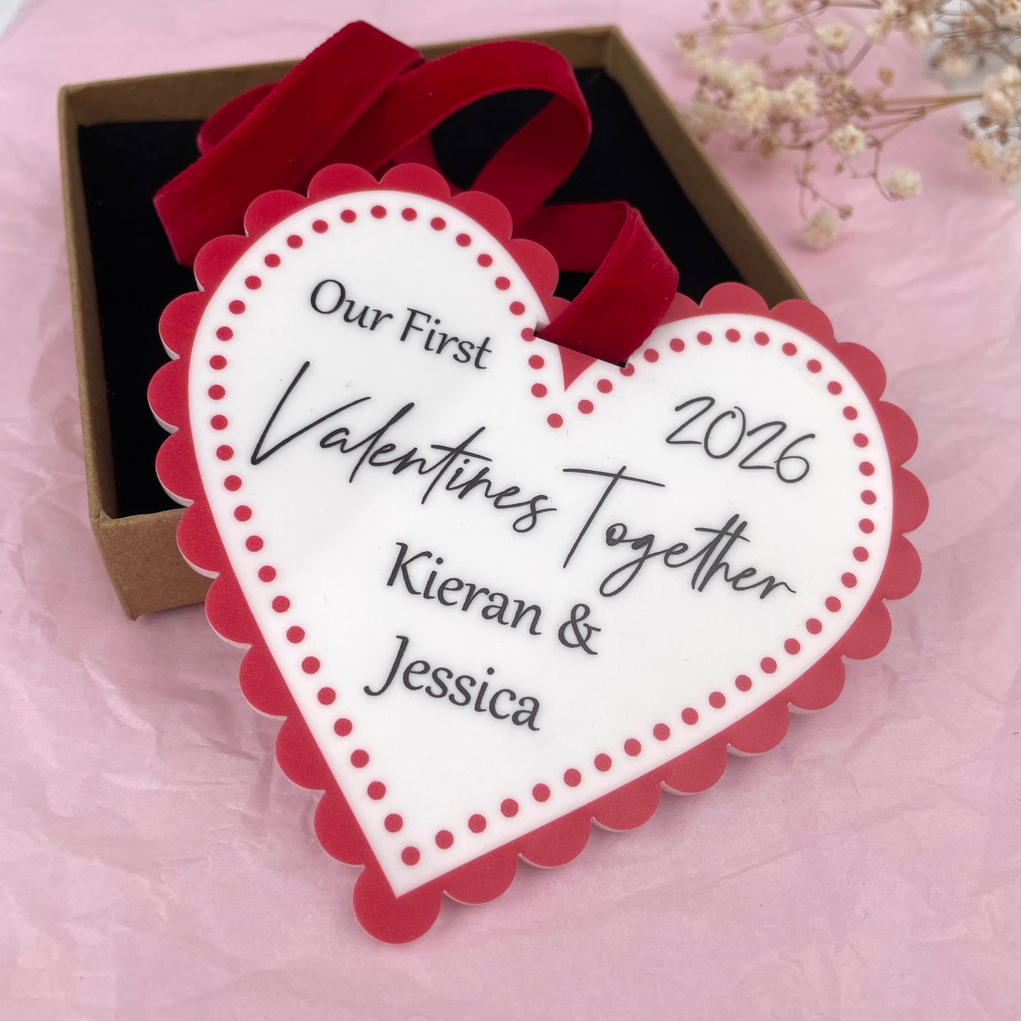 White and red acrylic printed valentines day heart customised with 'Our first valentines together 2026' 'Kieran & Jessica'. Made by The Bespoke Workshop.