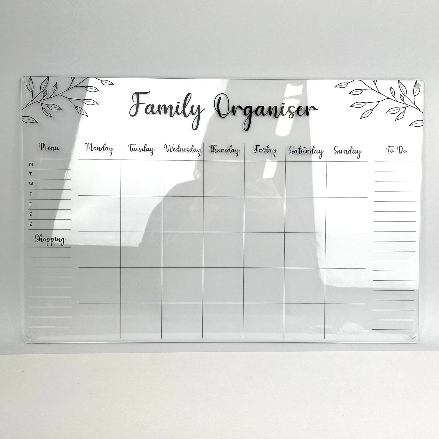Family organiser with daily schedule with black writing on clear acrylic