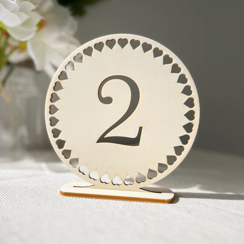 Round wooden laser cut wedding table numbers made by The Bespoke Workshop
