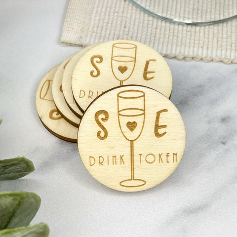 Round wooden personalised drinks token engraved with couples initials for their big day created by The Bespoke Workshop