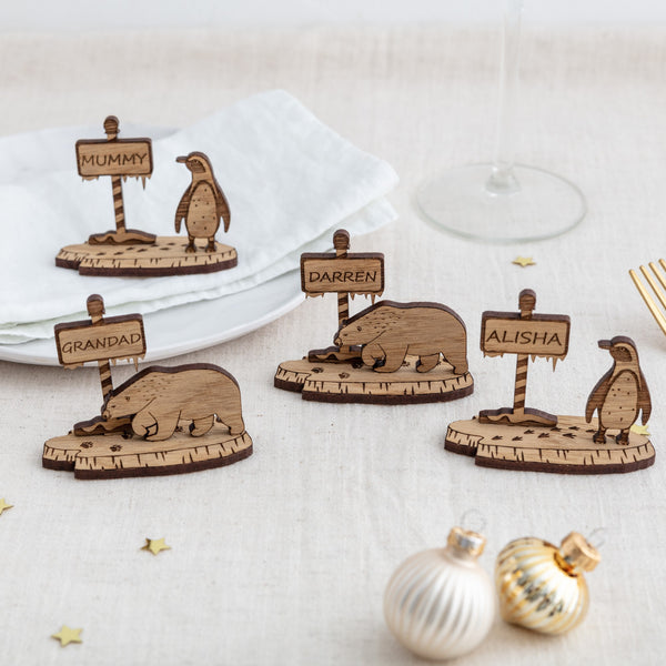 Wooden christmas table place settings in Penguins and Polar bears, personalised with a name engraved within the north pole sign post - the bespoke workshop